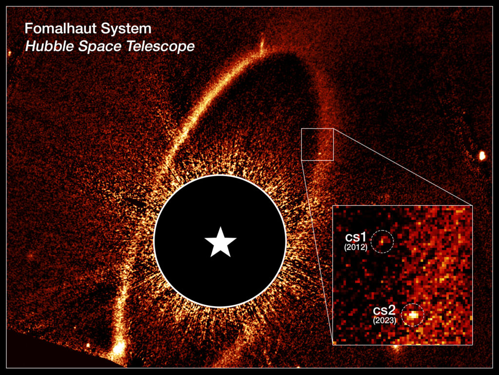 This composite Hubble Space Telescope image shows the debris ring and dust clouds cs1 and cs2 around the star Fomalhaut. For comparison, dust cloud cs1, imaged in 2012, is pictured with dust cloud cs2, imaged in 2023. The dashed circles mark the location of these clouds. When dust cloud cs2 suddenly appeared, astronomers quickly realized they had witnessed the violent collision of two massive objects. Previously thought to be a planet, cs1 is now classified as a similar debris cloud. In this image, Fomalhaut itself is masked out to allow the fainter features to be seen. Its location is marked by the white star. (Image Credit: NASA, ESA, Paul Kalas (UC Berkeley))