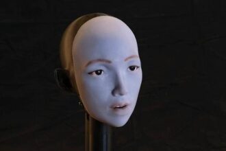 Humanoid robot with flexible facial skin and motors, performing lip movements to match speech and singing.